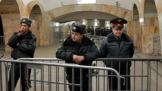 Interior Ministry officers keep watch at Kuznetsky Most metro station in Moscow