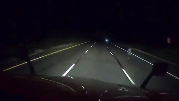 Truck driver captures mysterious ghostly figure standing on side of highway at night