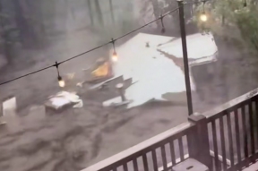 A stream of water demolishes residential buildings in New Mexico, killing two children