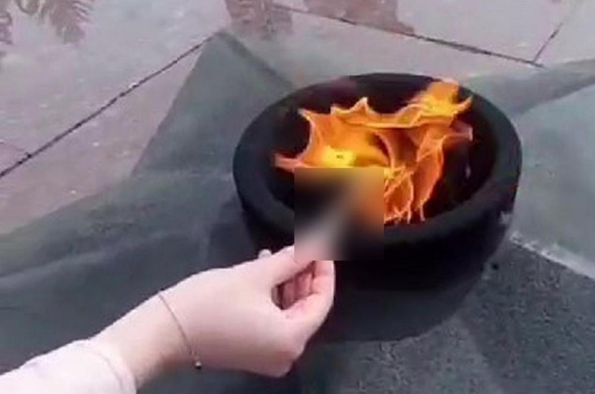 A case has been opened in Sakhalin over a video of a girl lighting a cigarette from the Eternal Flame, with townspeople condemning the cynical act