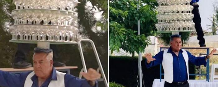 A local man in Cyprus set a record by dancing with 319 glasses on his head